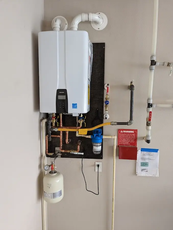 Professional plumber installing copper piping in a Anoka home